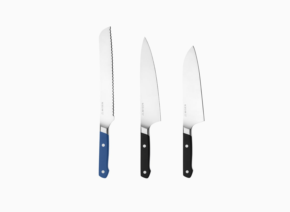 The Misen Big Knives bundle comes with an 8 inch blue Serrated Knife, a black 8 inch Chef's Knife and a black 8 inch Santoku Knife.