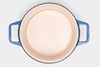 Blue Misen Dutch Oven without lid seen from above, showing light interior enamel on a white background.