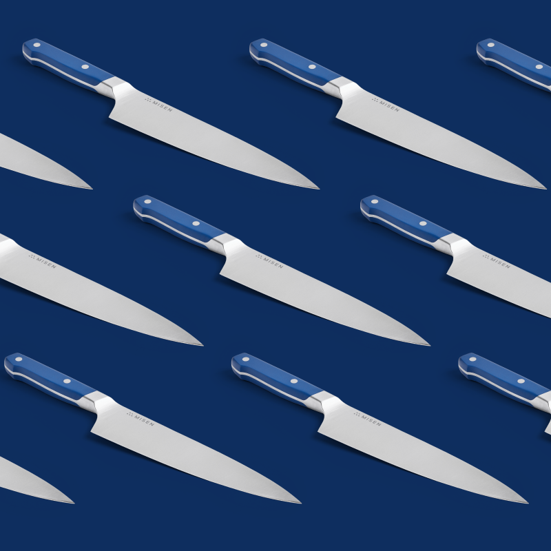 Misen chef's knife with blue handle on navy background