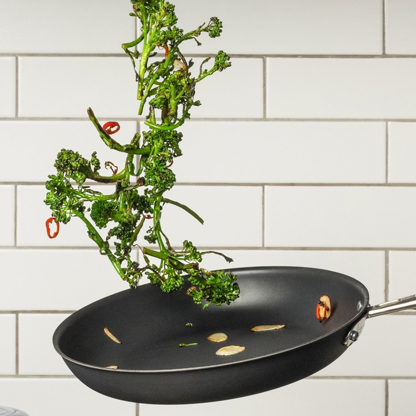 Broccolini tossed in a nonstick skillet with garlic and chili