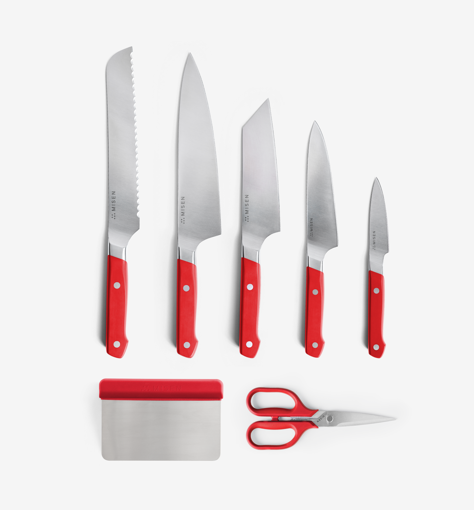 Misen 7-piece kitchen knife set with red handles including bread knife, chef knife, santoku, utility knife, paring knife, bench scraper, and kitchen shears
