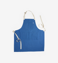 Blue linen bib apron with adjustable neck strap and cream canvas ties
