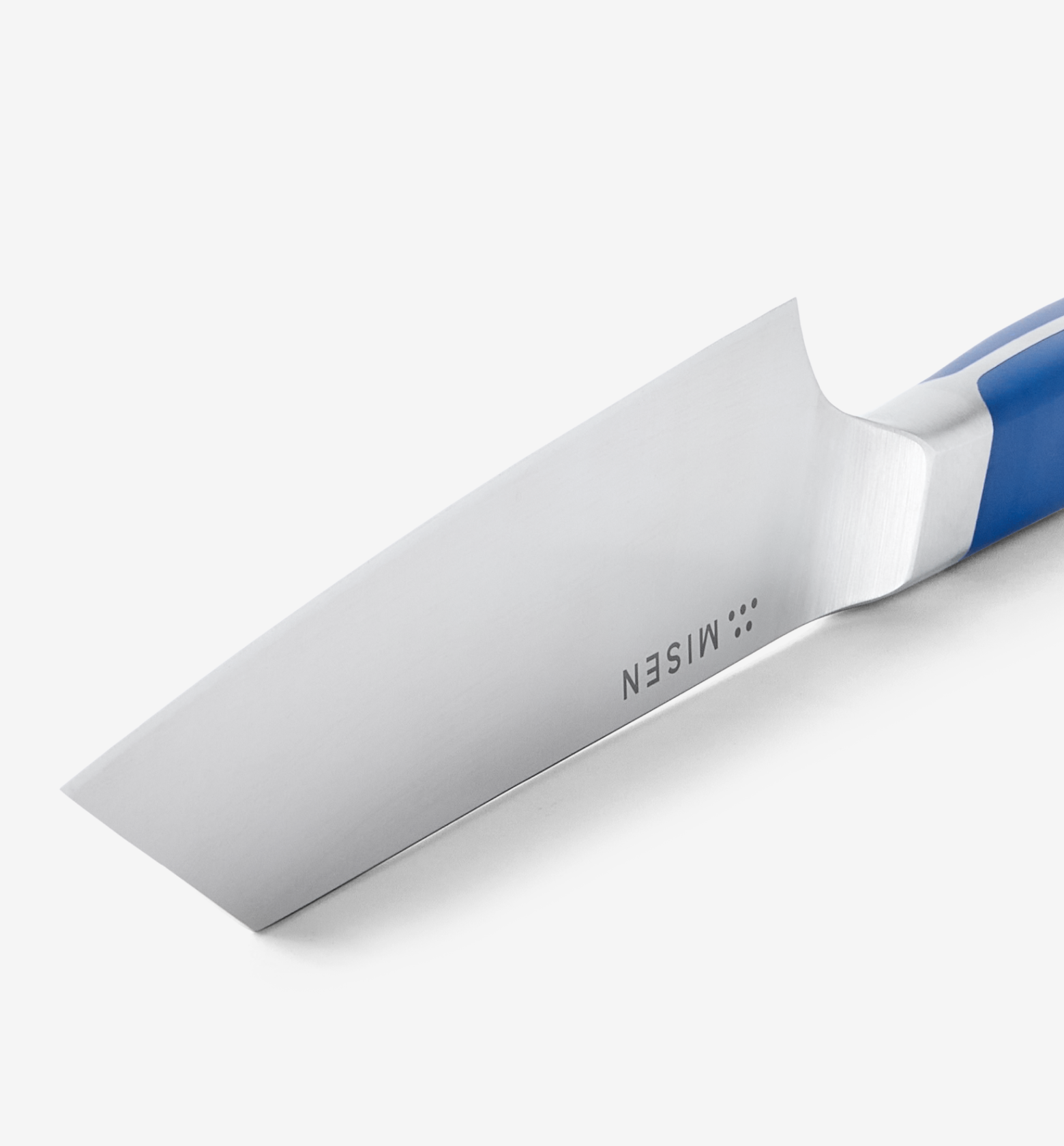 Misen kitchen knife blade close-up with blue handle and stainless steel finish