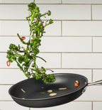 Broccolini tossed in nonstick skillet with garlic and red chili