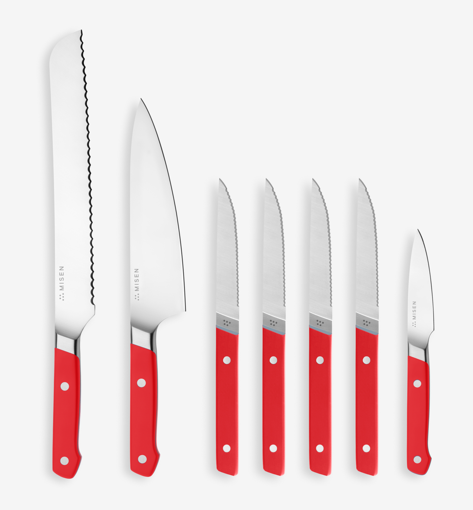 Misen 7-piece knife set with red handles including bread knife, chef's knife, steak knives, and paring knife