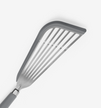 Slotted spatula with flexible head and ergonomic gray handle