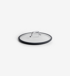 Clear glass pan lid with stainless steel handle and black silicone rim