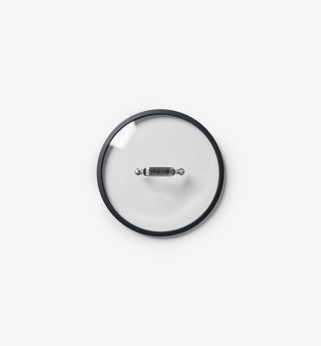 Glass pot lid with stainless steel handle and black silicone rim, top view