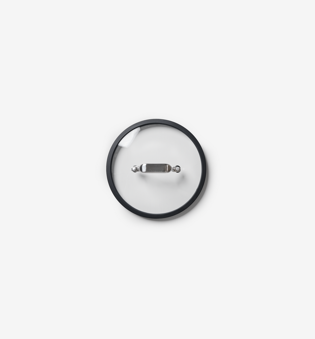 Glass pot lid with stainless steel handle and silicone rim, top view