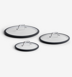 Set of three glass pan lids with silicone rims and stainless steel handles in small, medium, and large sizes