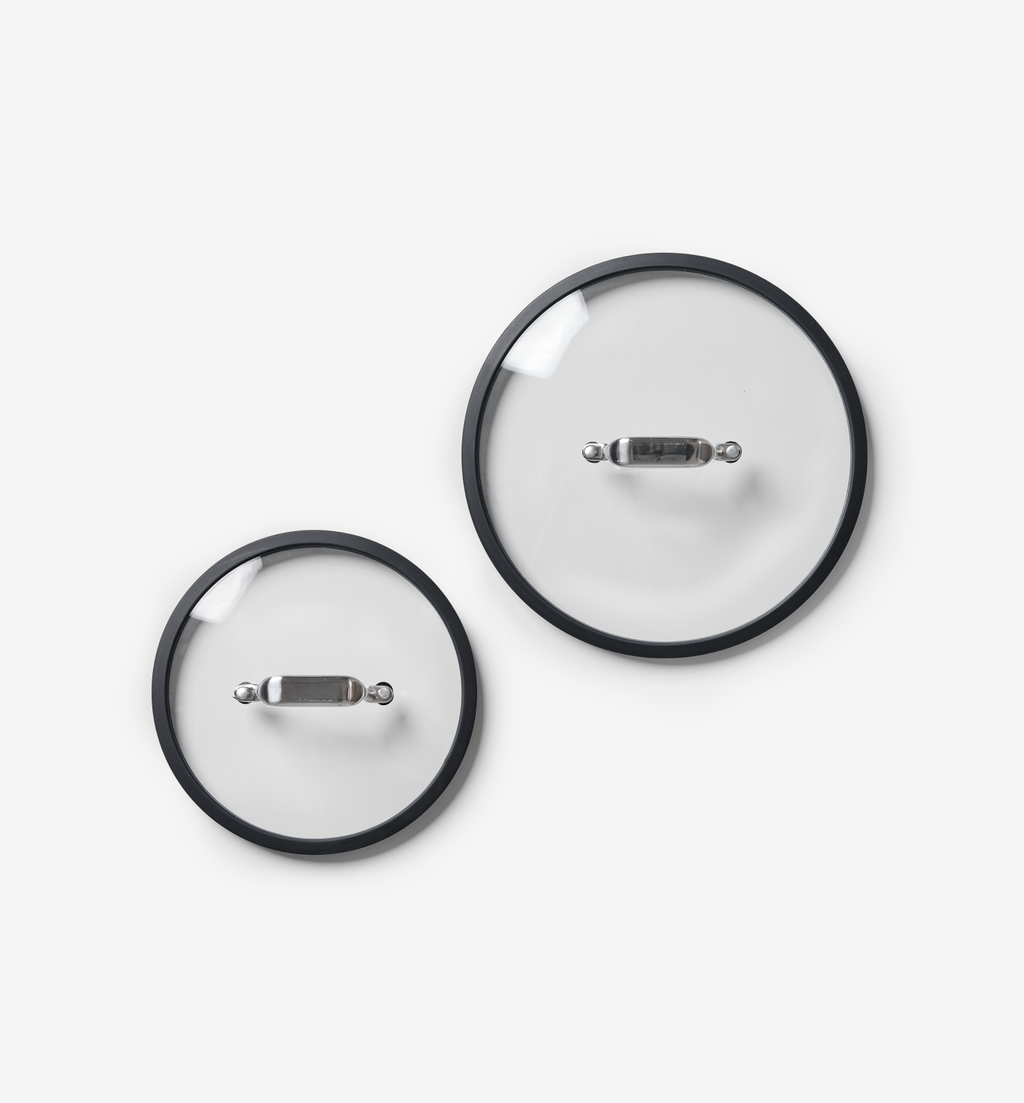 Glass cookware lids with black rim and stainless steel handle, set of two sizes