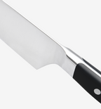 Professional chef's knife with stainless steel blade and black handle close-up