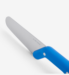 Misen kitchen knife with blue handle, stainless steel blade close-up