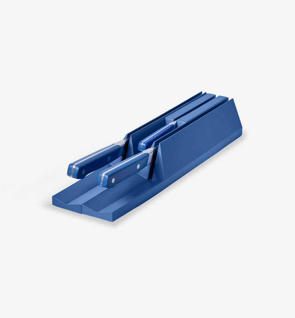 Blue knife drawer organizer block holding matching blue-handled kitchen knives