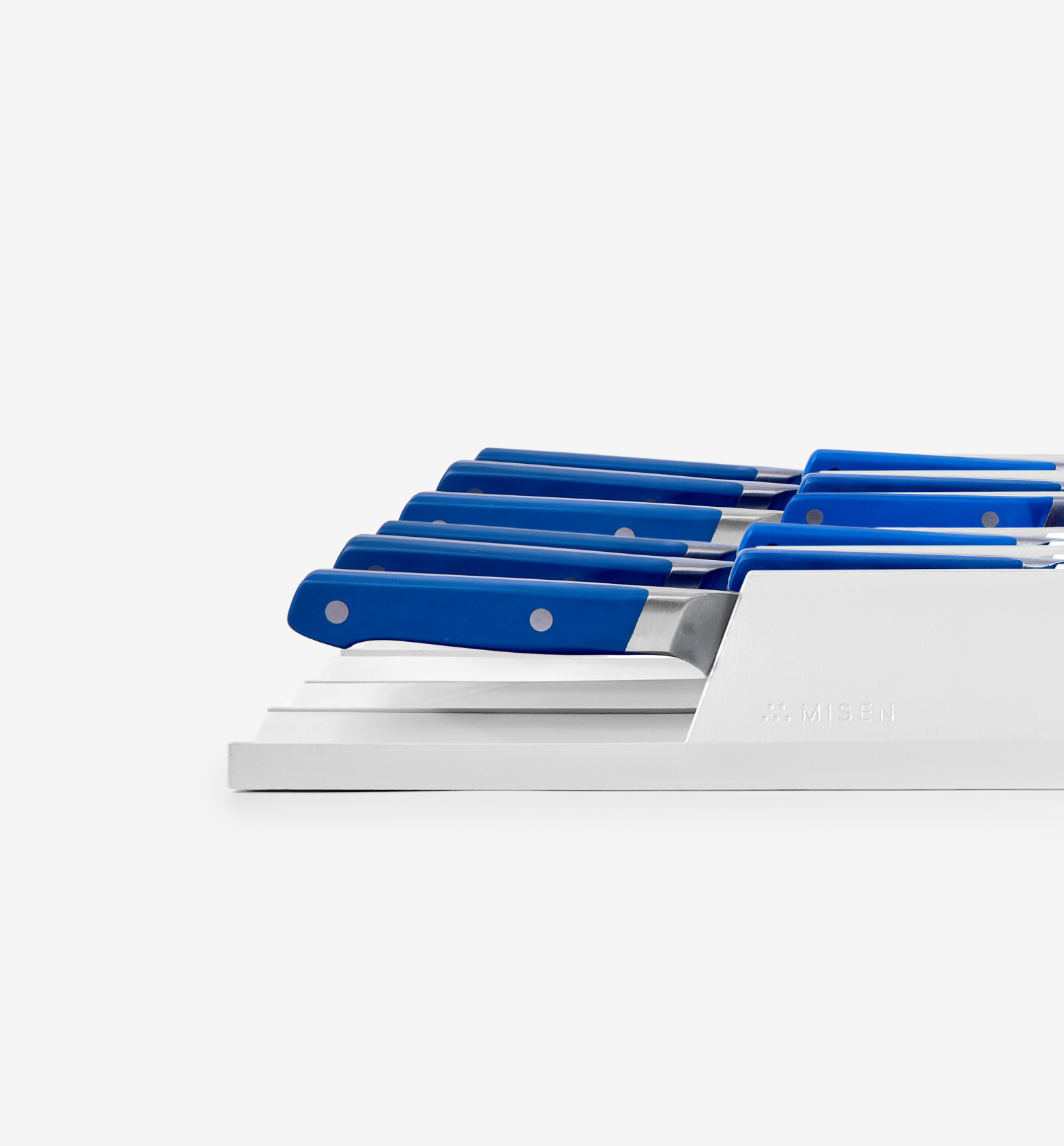 Misen steak knife set with blue handles in white drawer organizer