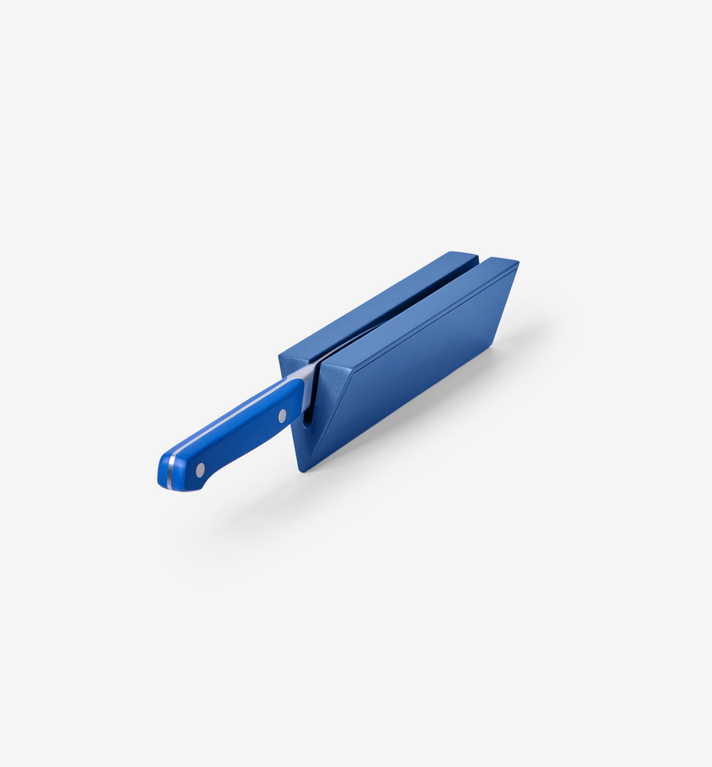 Blue knife sharpener block with matching blue handle kitchen knife inserted