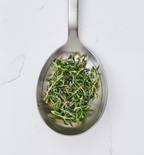 One tablespoon of fresh thyme leaves on stainless steel measuring spoon
