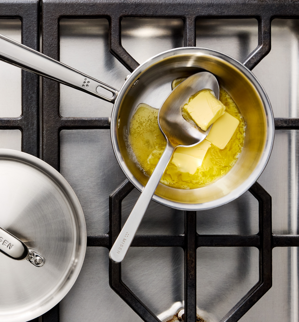 Misen saucepan melting butter on gas stove with stainless spoon