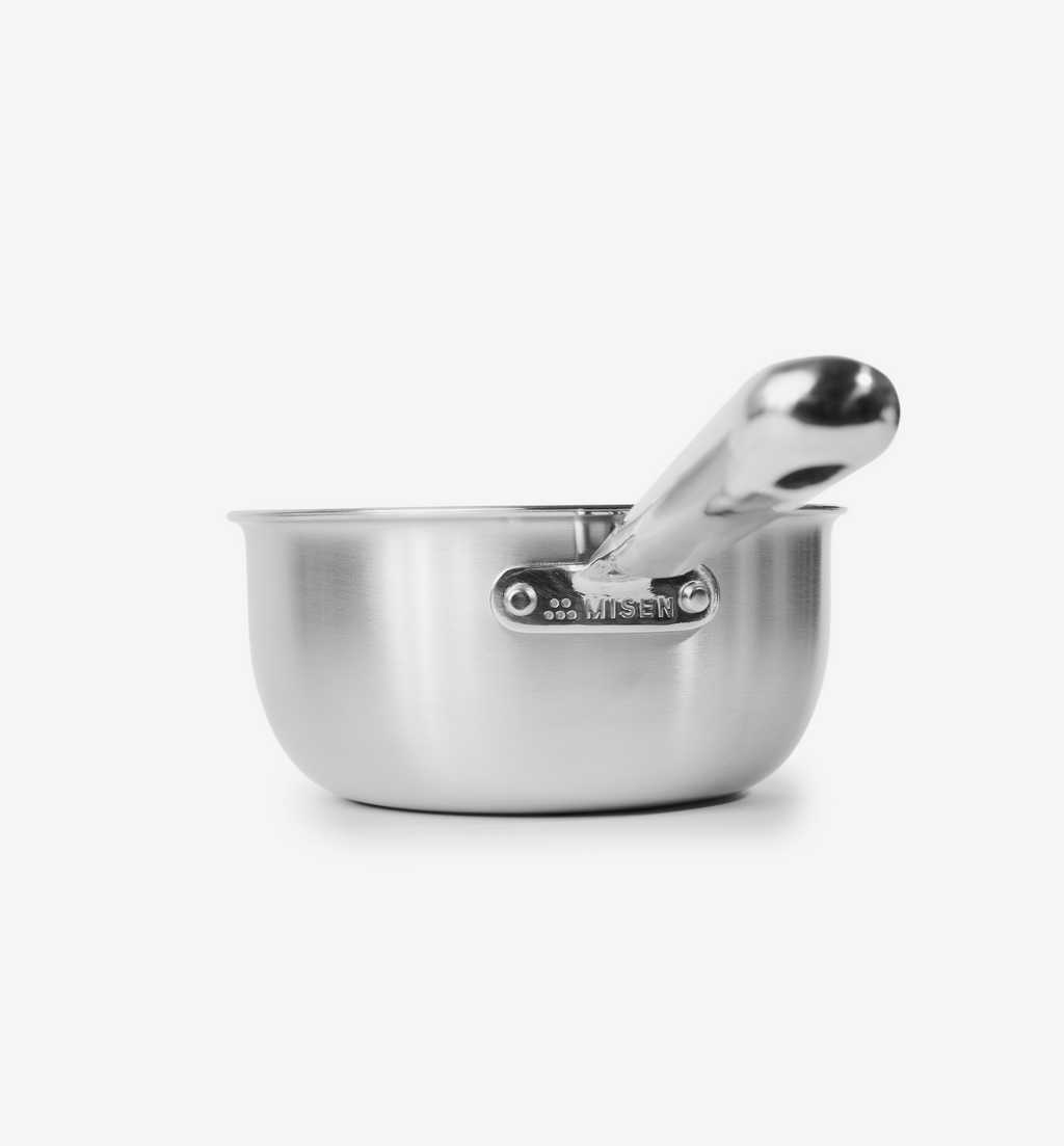 Misen stainless steel saucier pan with handle resting inside