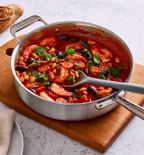Shrimp and white bean tomato stew with olives and fresh herbs in a Misen stainless steel pan