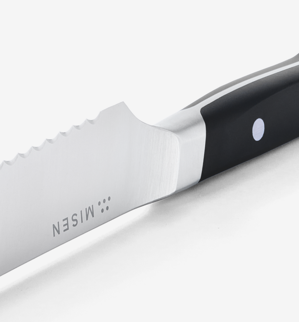 Misen steak knife serrated blade close-up with black handle