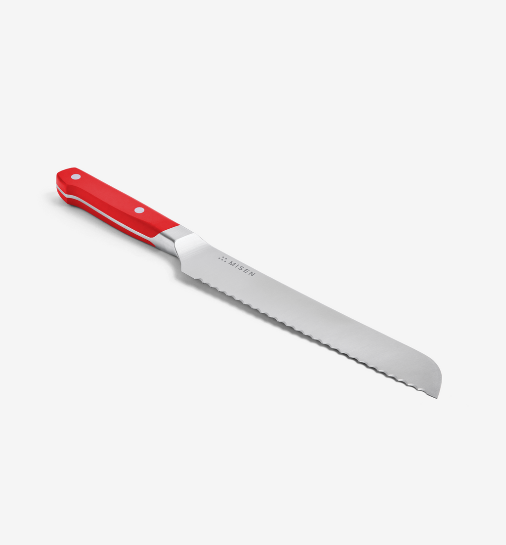 Misen bread knife with red handle and serrated stainless steel blade