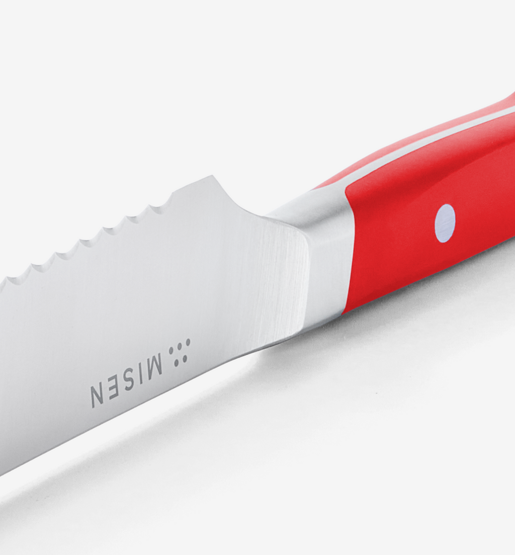 Misen steak knife serrated blade with red handle close-up