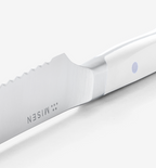 Misen steak knife close-up showing serrated blade and white handle