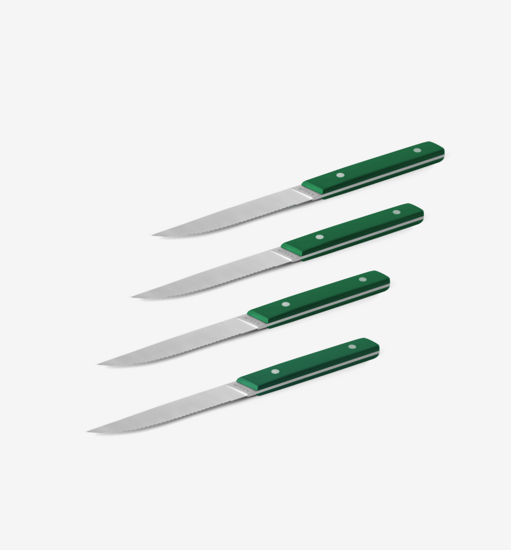 Set of 4 steak knives with green handles and serrated blades