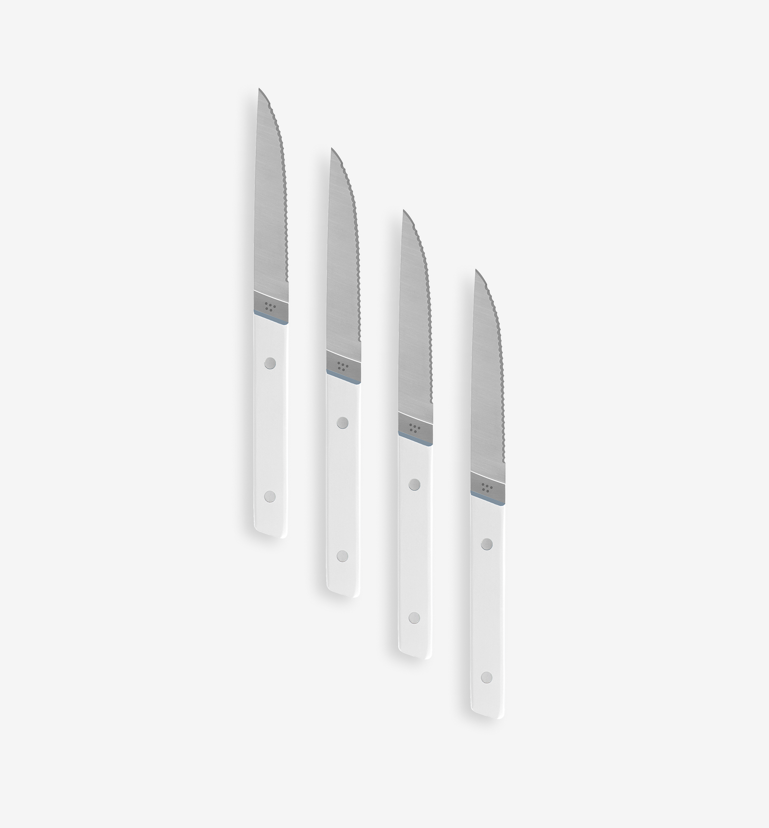 Set of 4 steak knives with serrated blades and white handles