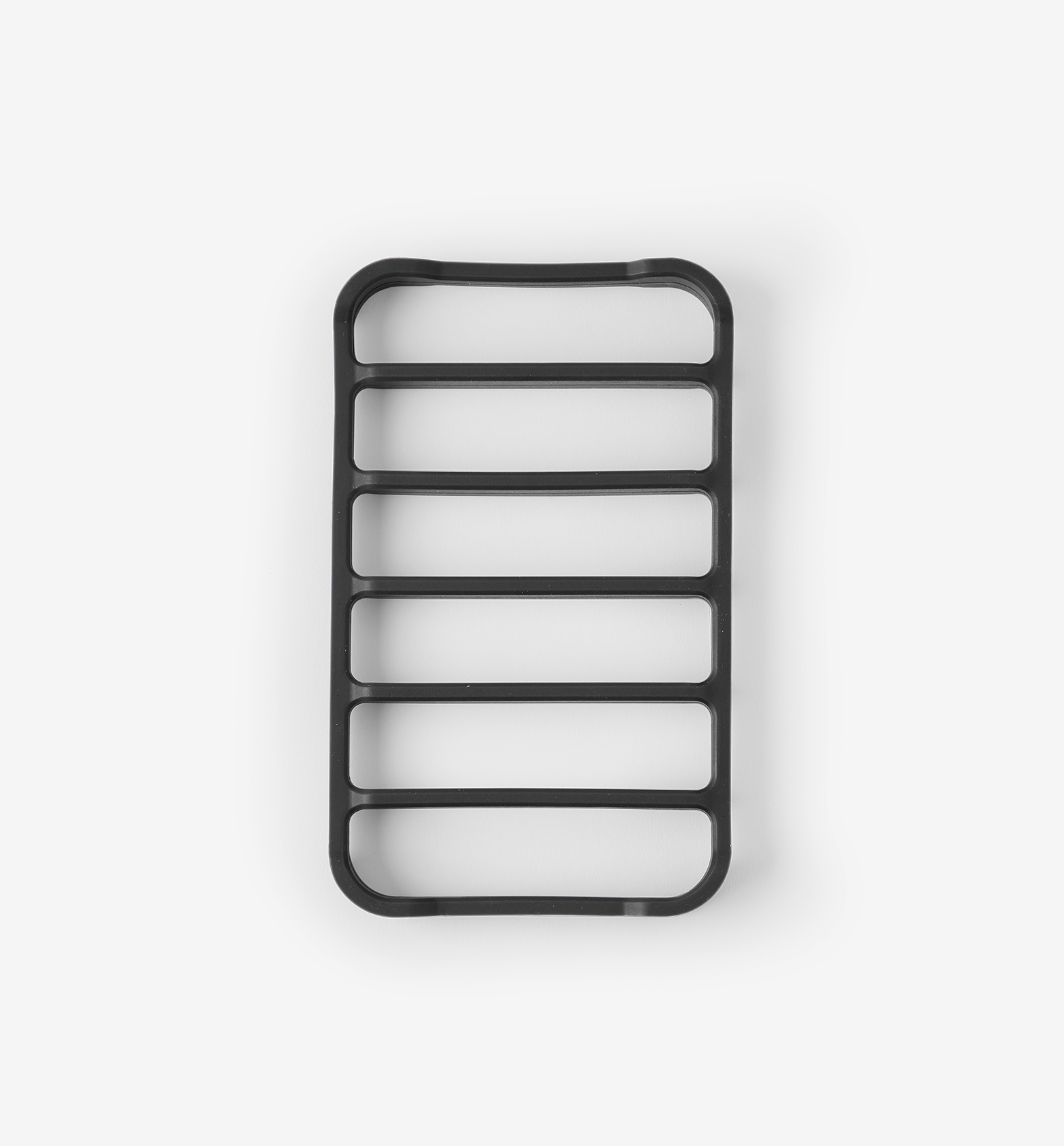 Black rectangular silicone trivet with six parallel slots and rounded corners