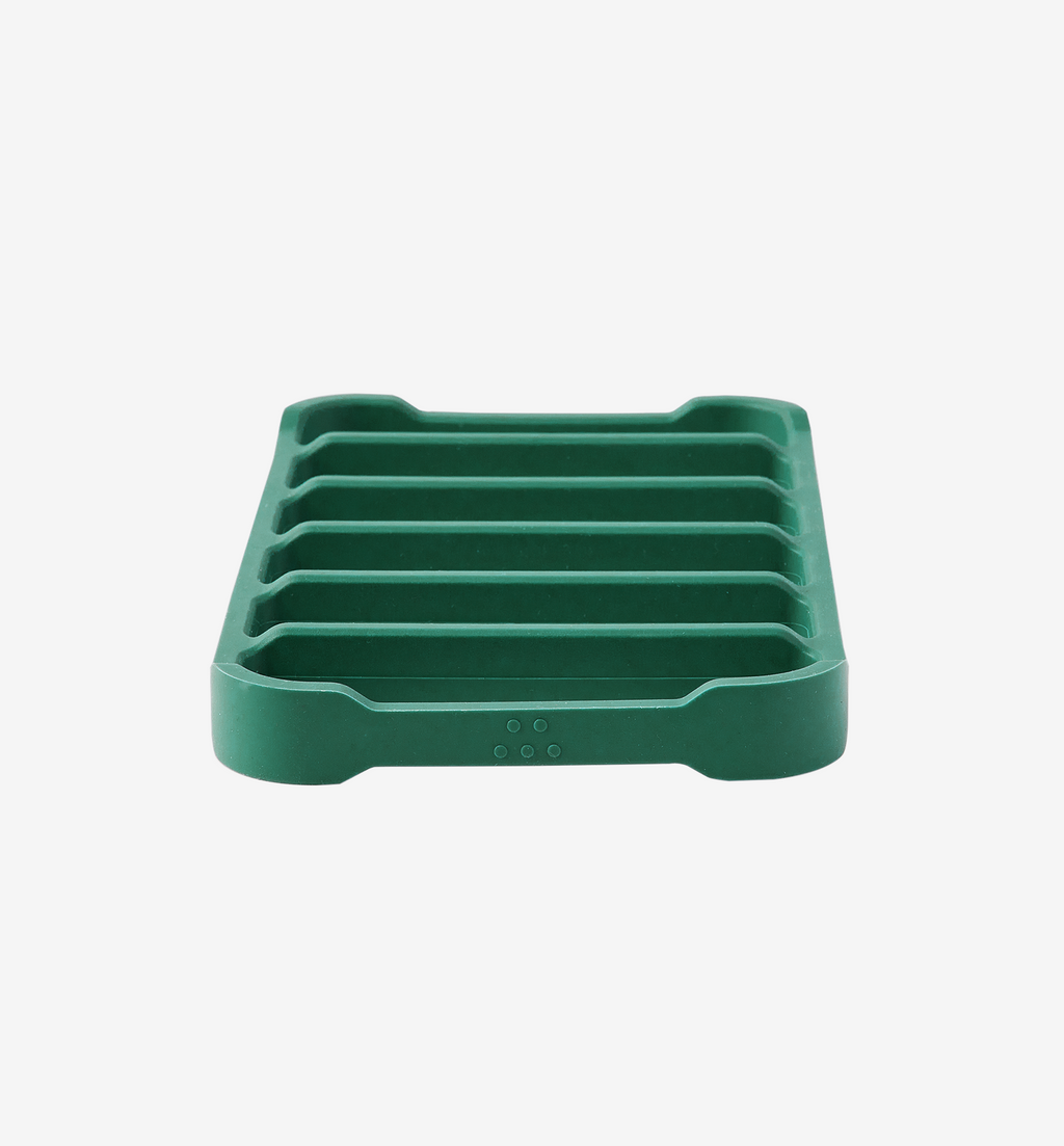 Green silicone soap dish with ribbed drainage design