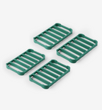 Set of 4 green silicone trivets with slatted design for heat protection