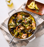 Seafood paella with shrimp, mussels, and calamari in a Misen stainless steel pan
