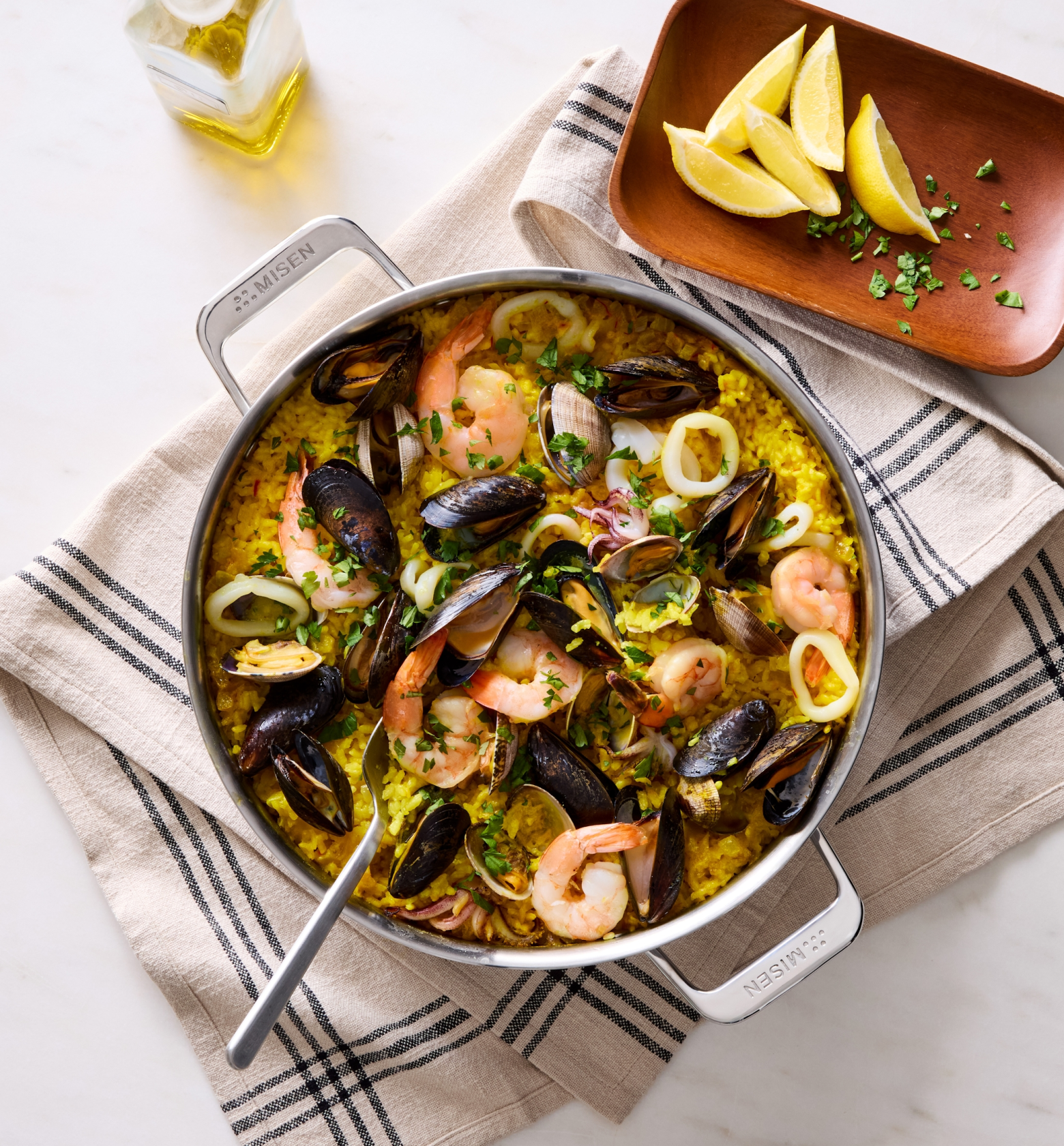 Seafood paella with shrimp, mussels, and calamari in a Misen stainless steel pan
