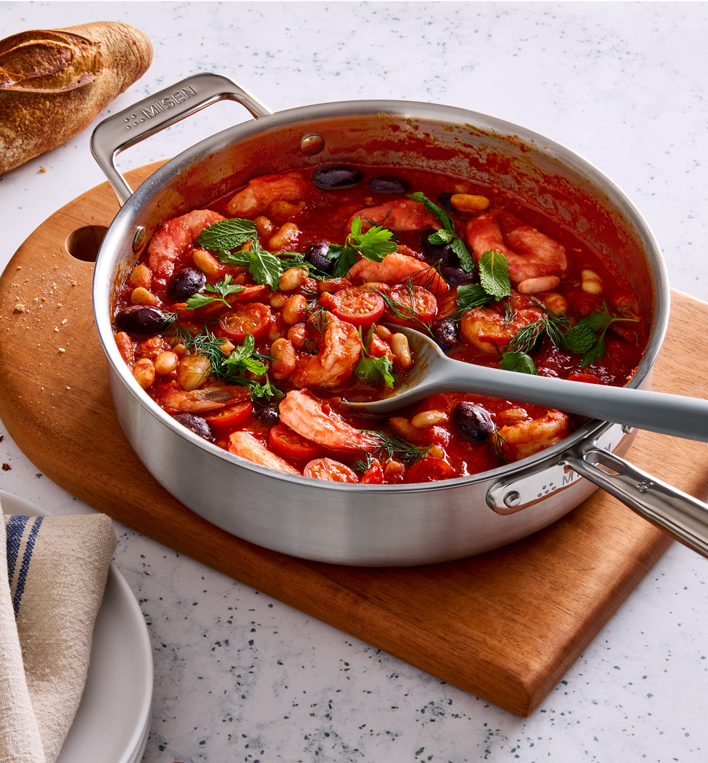 Misen stainless steel braiser pan with shrimp tomato bean stew garnished with fresh herbs