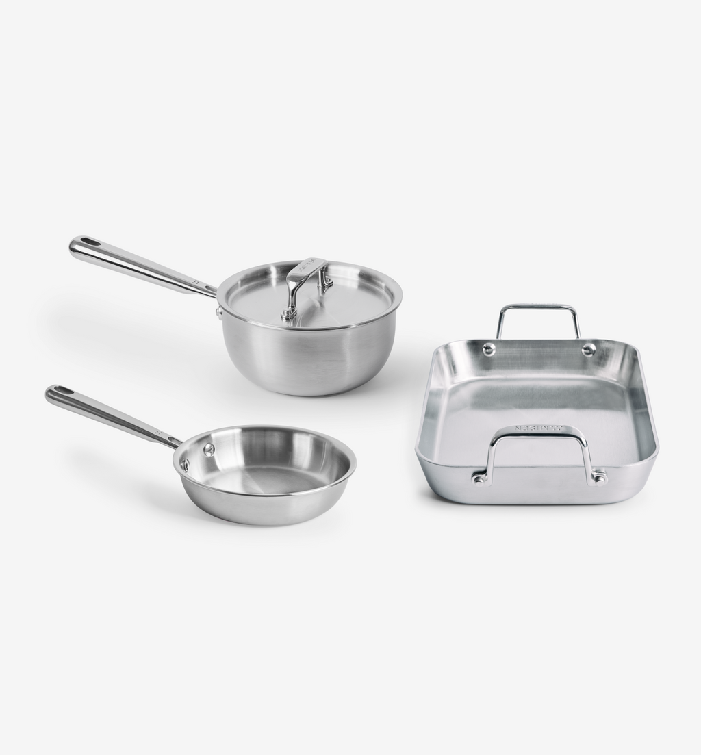 Stainless steel cookware set with saucepan, frying pan, and roasting pan