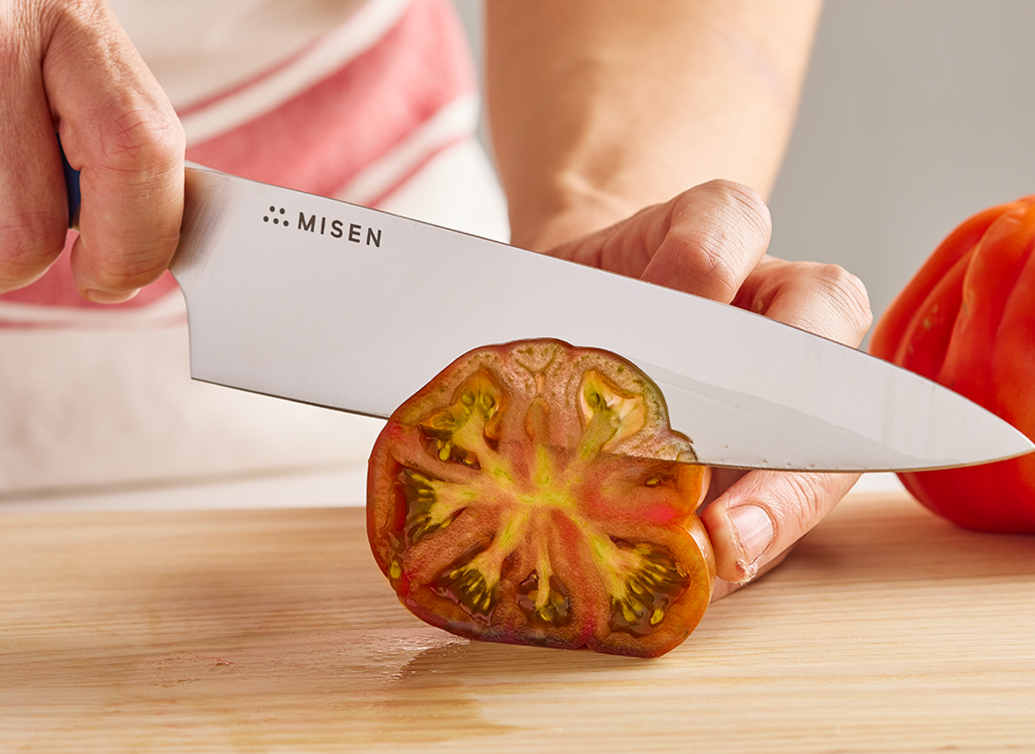 Slicing a beef tomato with an 8 inch Misen Chef's Knife.