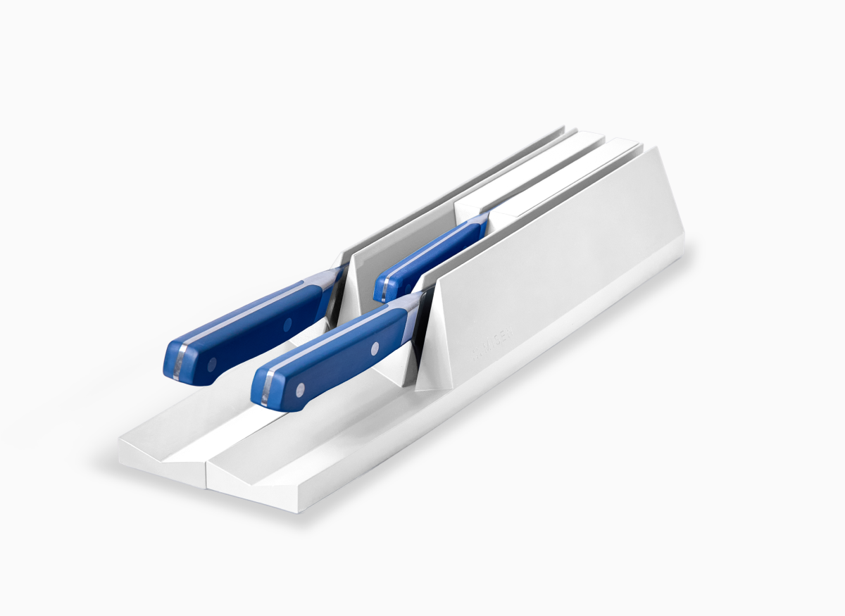 A white 3-piece modular knife storage system with blue-handled knives securely placed in slots.